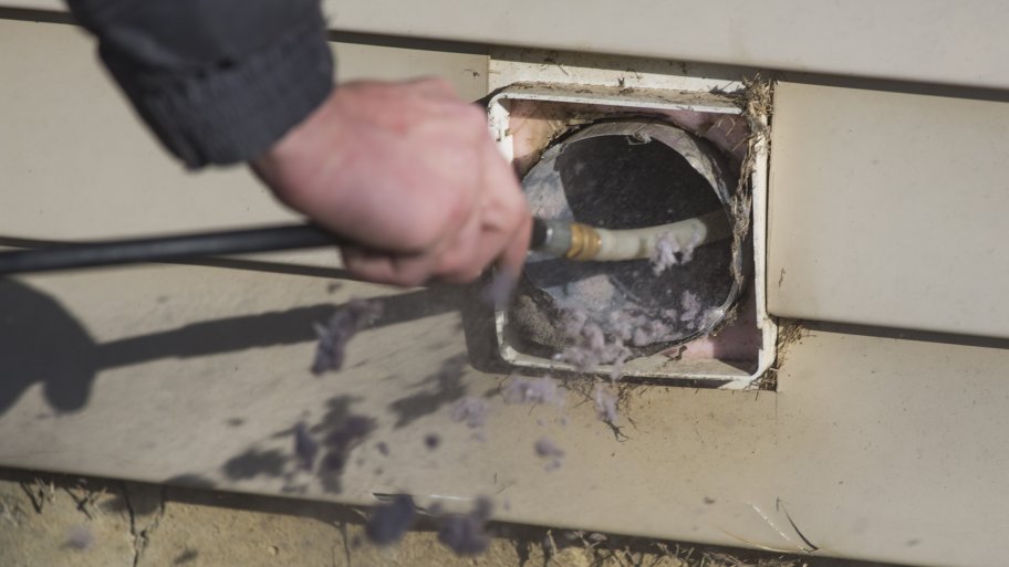 Midwest Air Solutions technician Simon Ashmore performs a dryer vent cleaning at a home in Zionsville, IN.